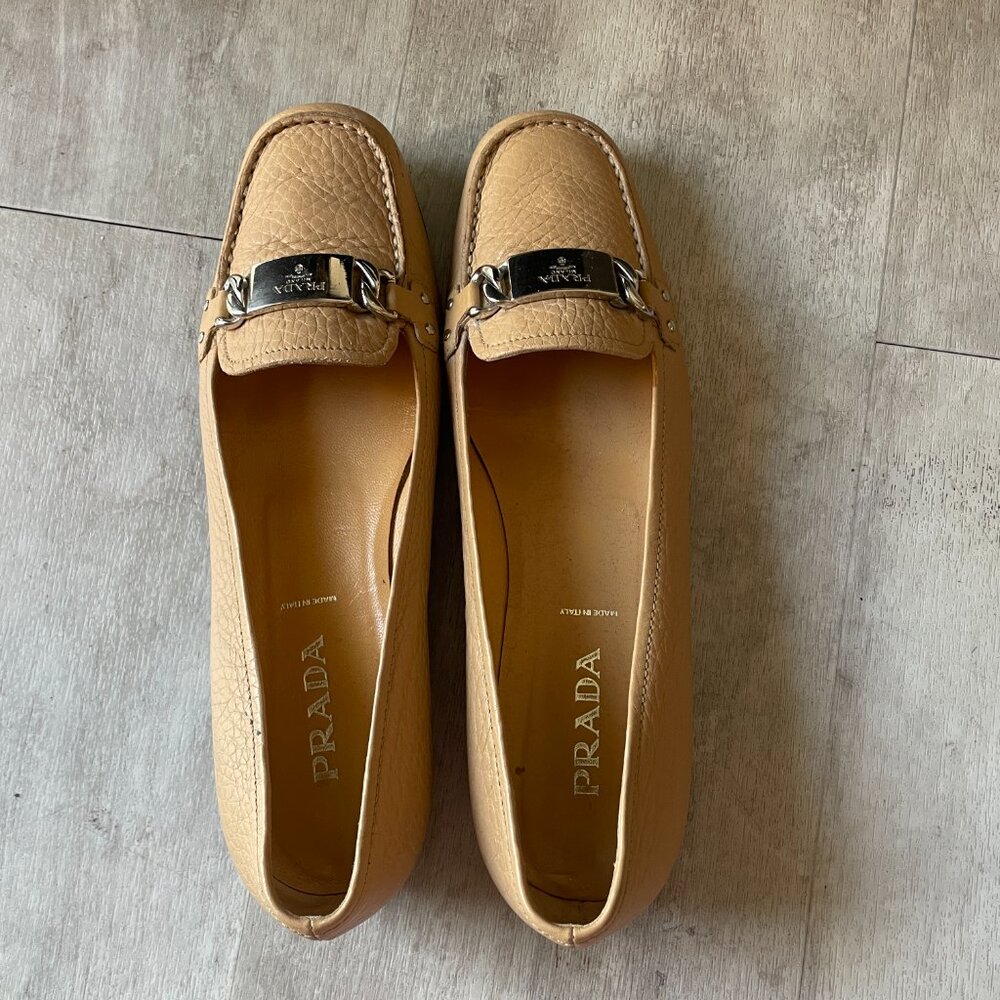Tan Leather Prada Loafers with a silver hardware nameplate